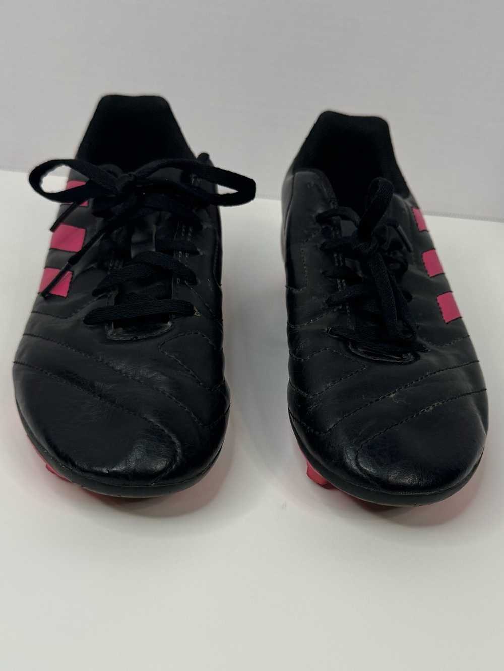 adidas Kids Black Soccer Cleats with Pink Stripes and Spikes